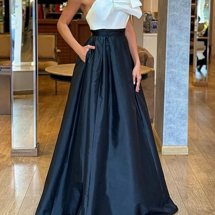 Elegant evening gown with white top and navy blue skirt, ideal for fashion occasions