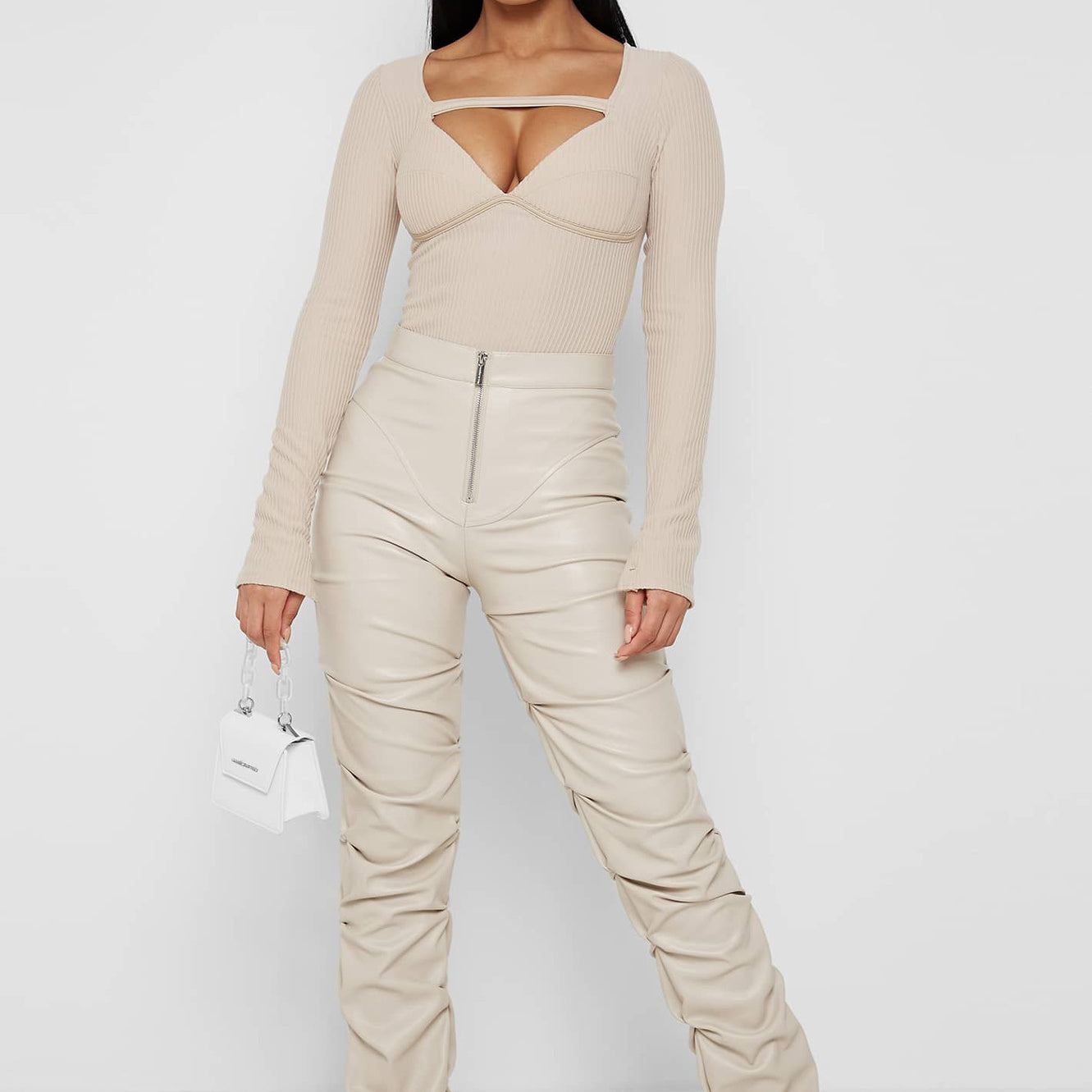 Woman in beige bodysuit and ruched pants wearing Faux Leather Langry fashion ensemble