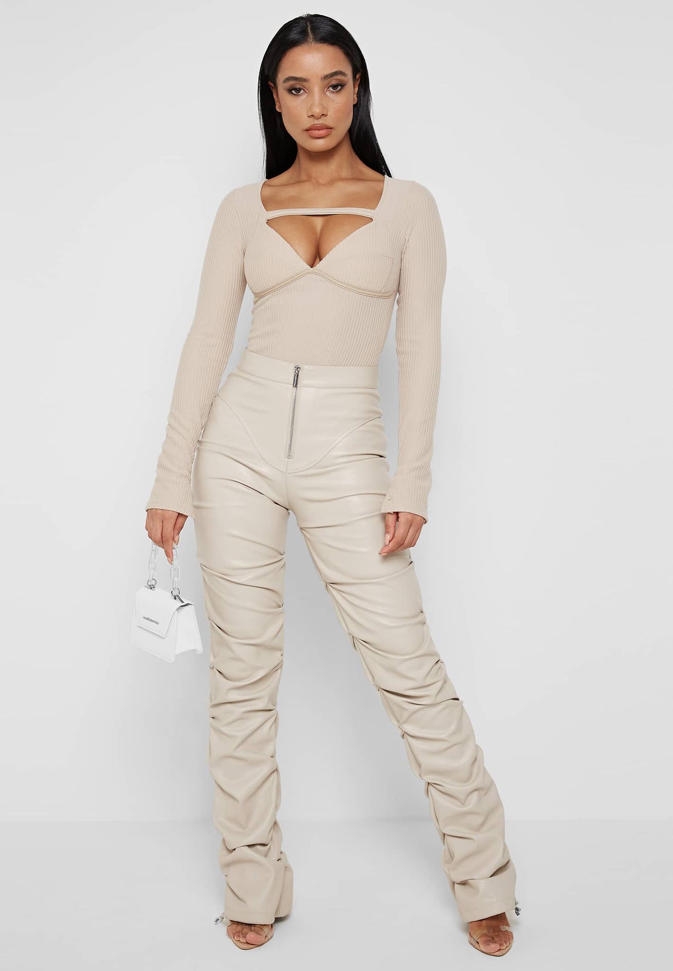 Woman in beige bodysuit and ruched pants wearing Faux Leather Langry fashion ensemble