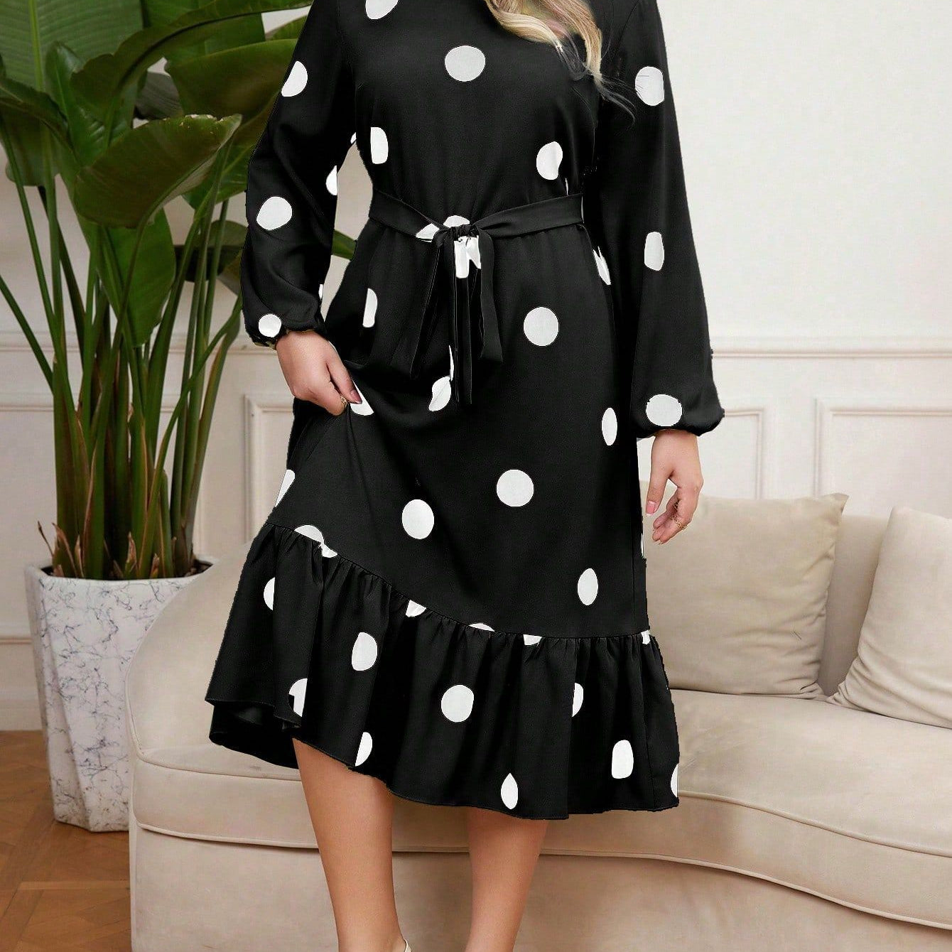 Black long-sleeved Lotus Leaf Dress with polka dots and ruffled hem for elegant style