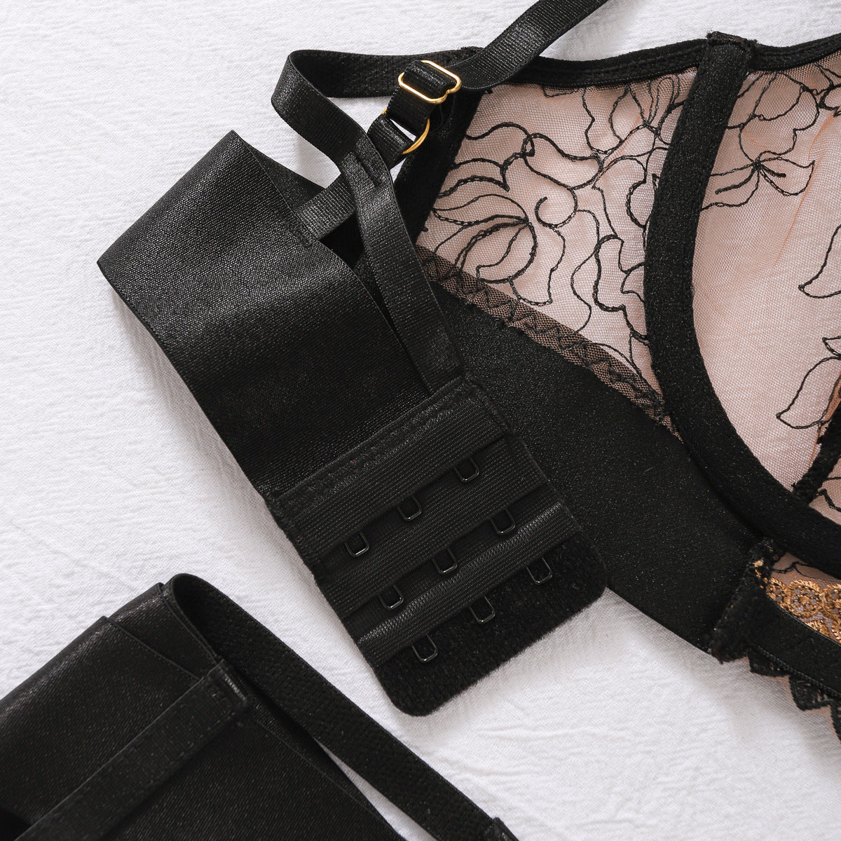 Black lace lingerie set with gold hardware and embroidery
