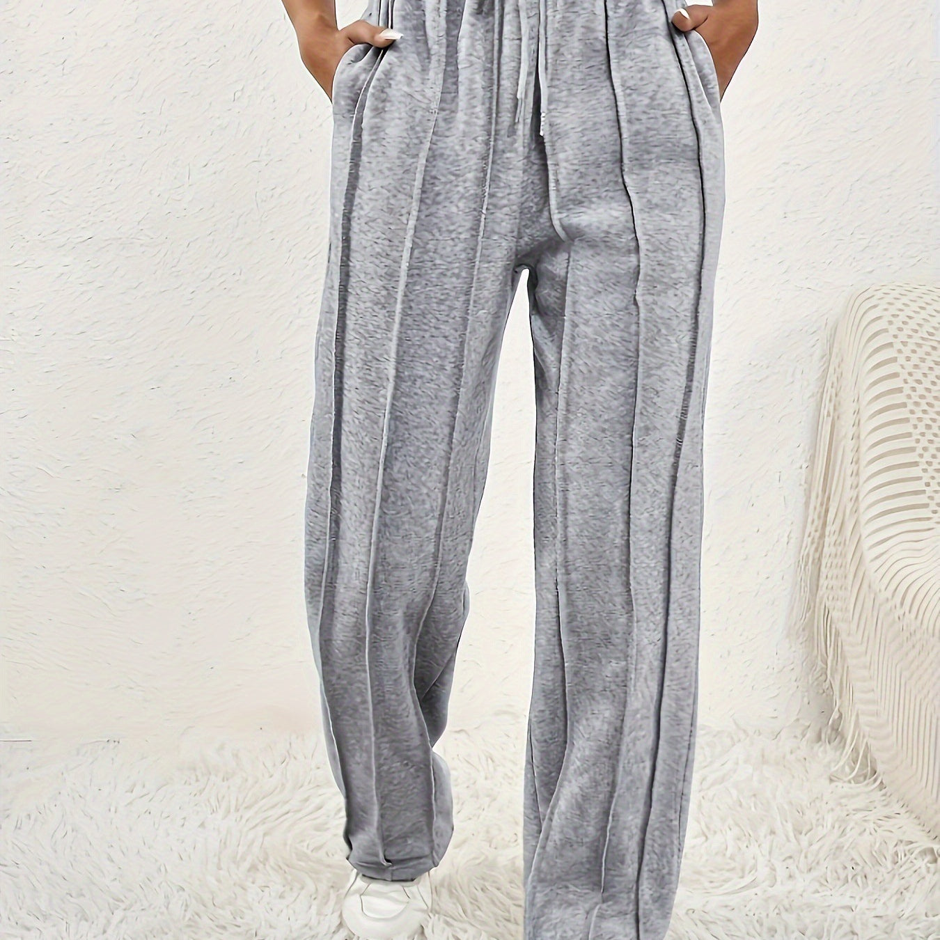 Light gray wide leg sweatpants with pinstripes and adjustable drawstring waistband