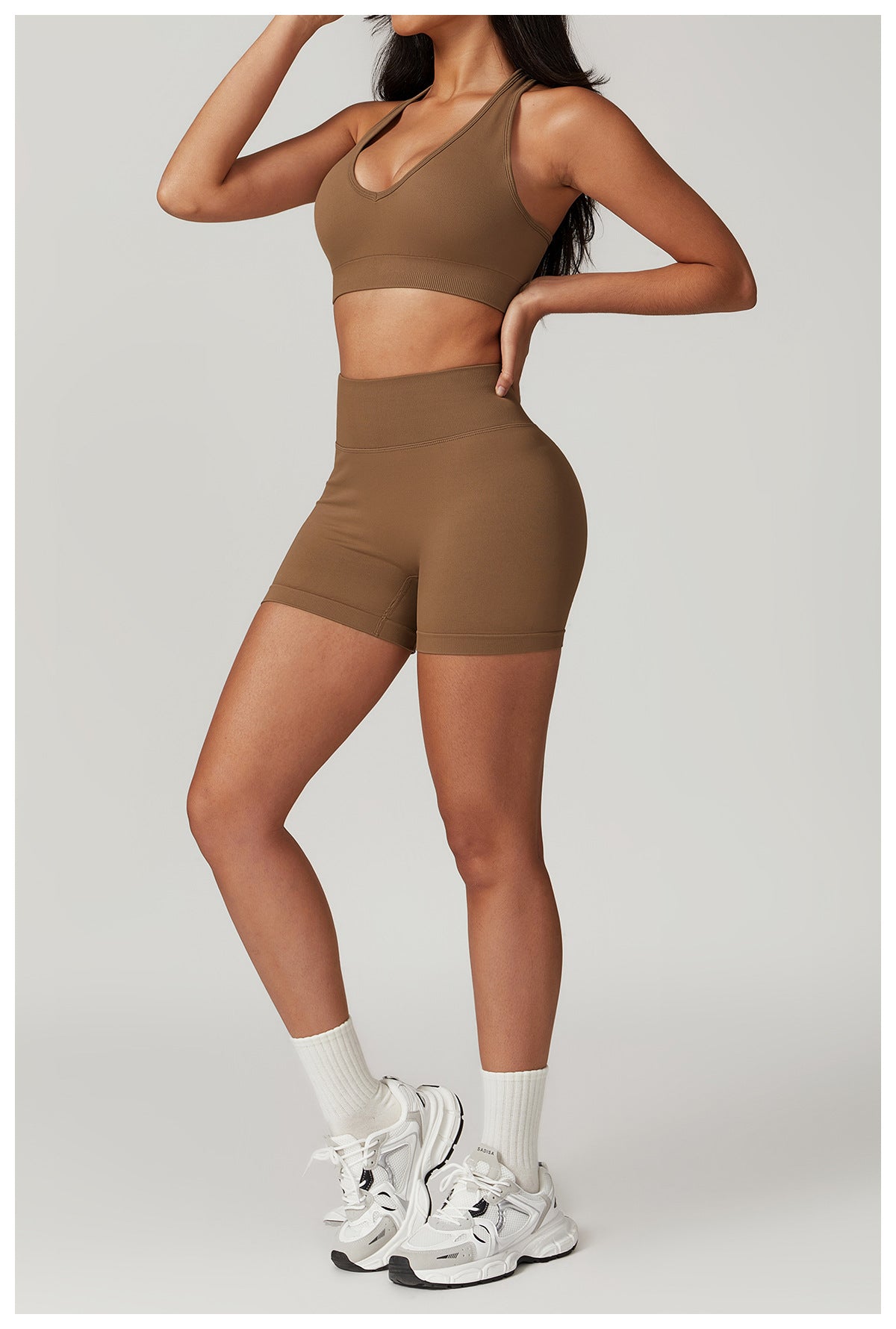 Woman wearing a brown Seamless Yoga Suit, featuring Bra Shorts Rhino design