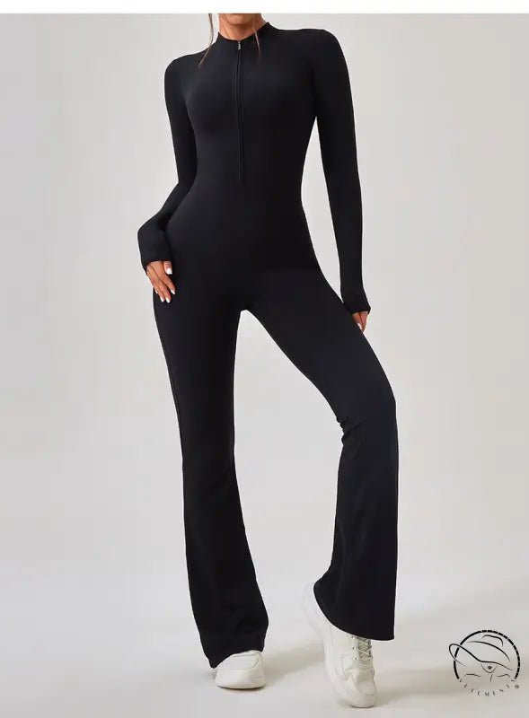 Black long-sleeved zip-up one piece sportswear jumpsuit with flared legs and white sneakers