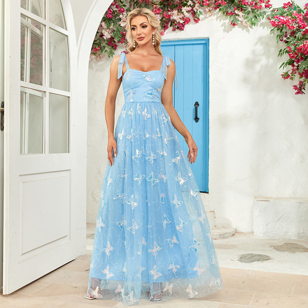 Light blue tulle gown with butterfly embellishments, perfect for elegant fashion events
