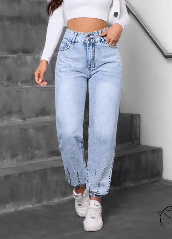 Light-wash match beaded straight jeans with cinched ankles and white sneakers