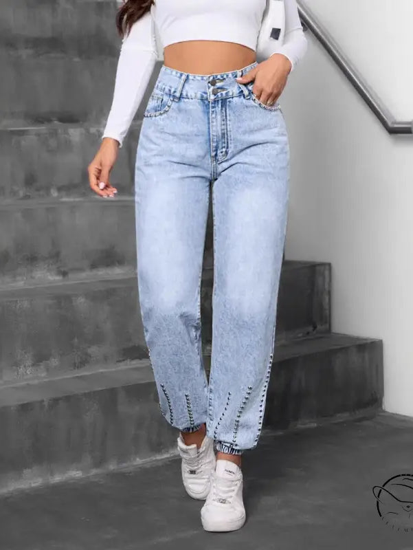 Light-wash match beaded straight jeans with cinched ankles and white sneakers