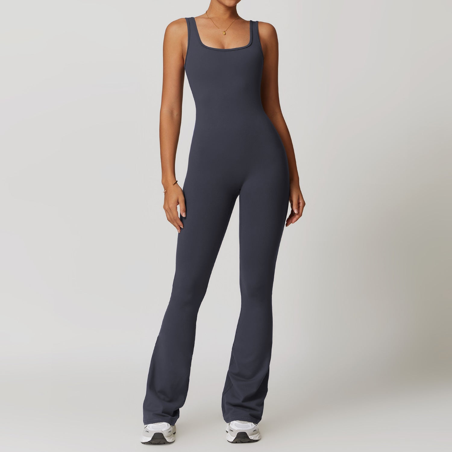 Sleeveless charcoal gray fitted jumpsuit with flared legs for stylish yoga fashion