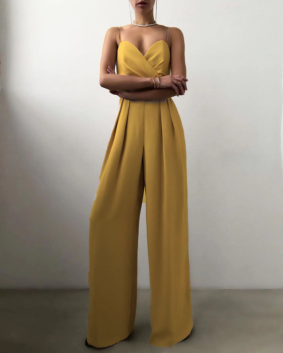 Mustard yellow strapless jumpsuit with pleated wide-leg pants for modern fashion ملابس