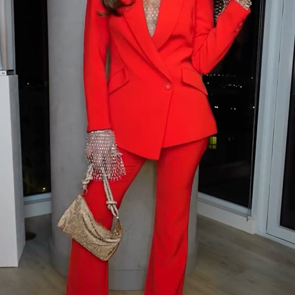 Woman in red pantsuit showcasing casual professional fashion and ملابس for elegant style