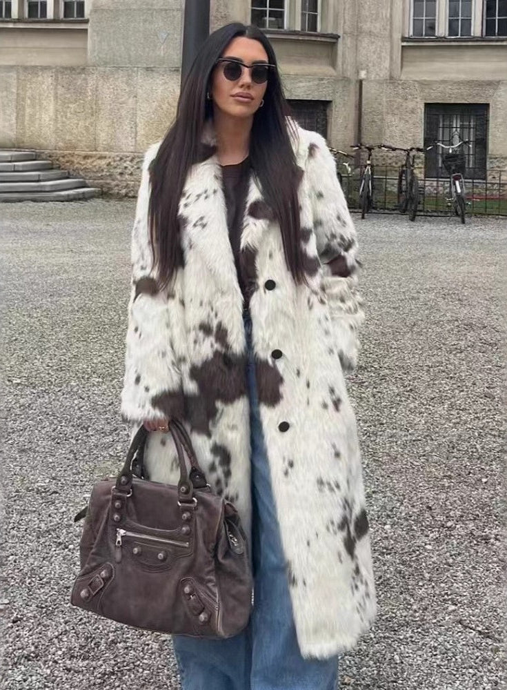 Cozy faux fur long coat in cow print with brown leather accents