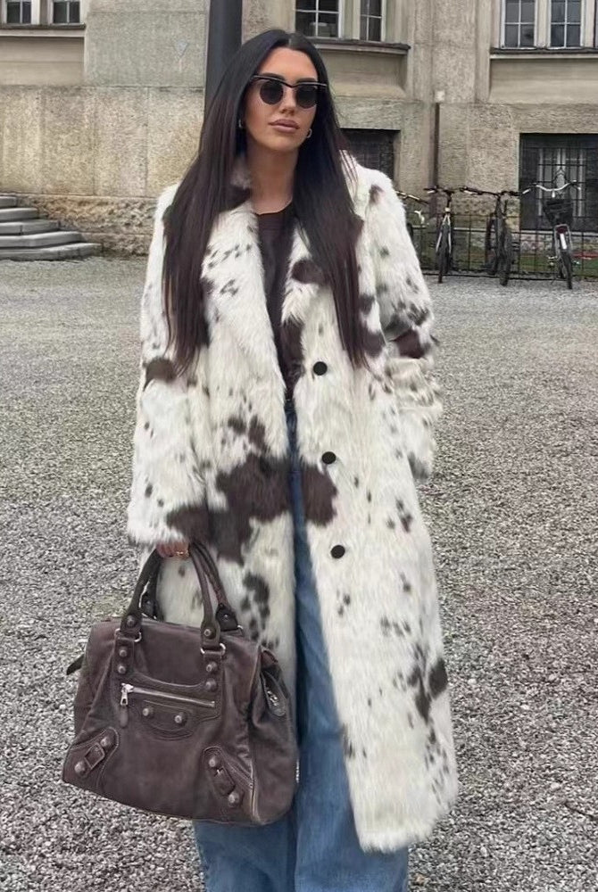 Cozy faux fur long coat in cow print with brown leather accents