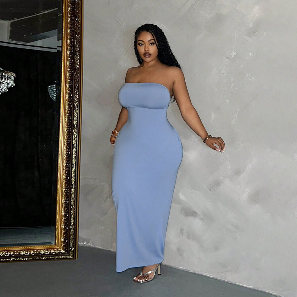 Woman in a strapless blue maxi dress showcasing elegant fashion and a flattering silhouette
