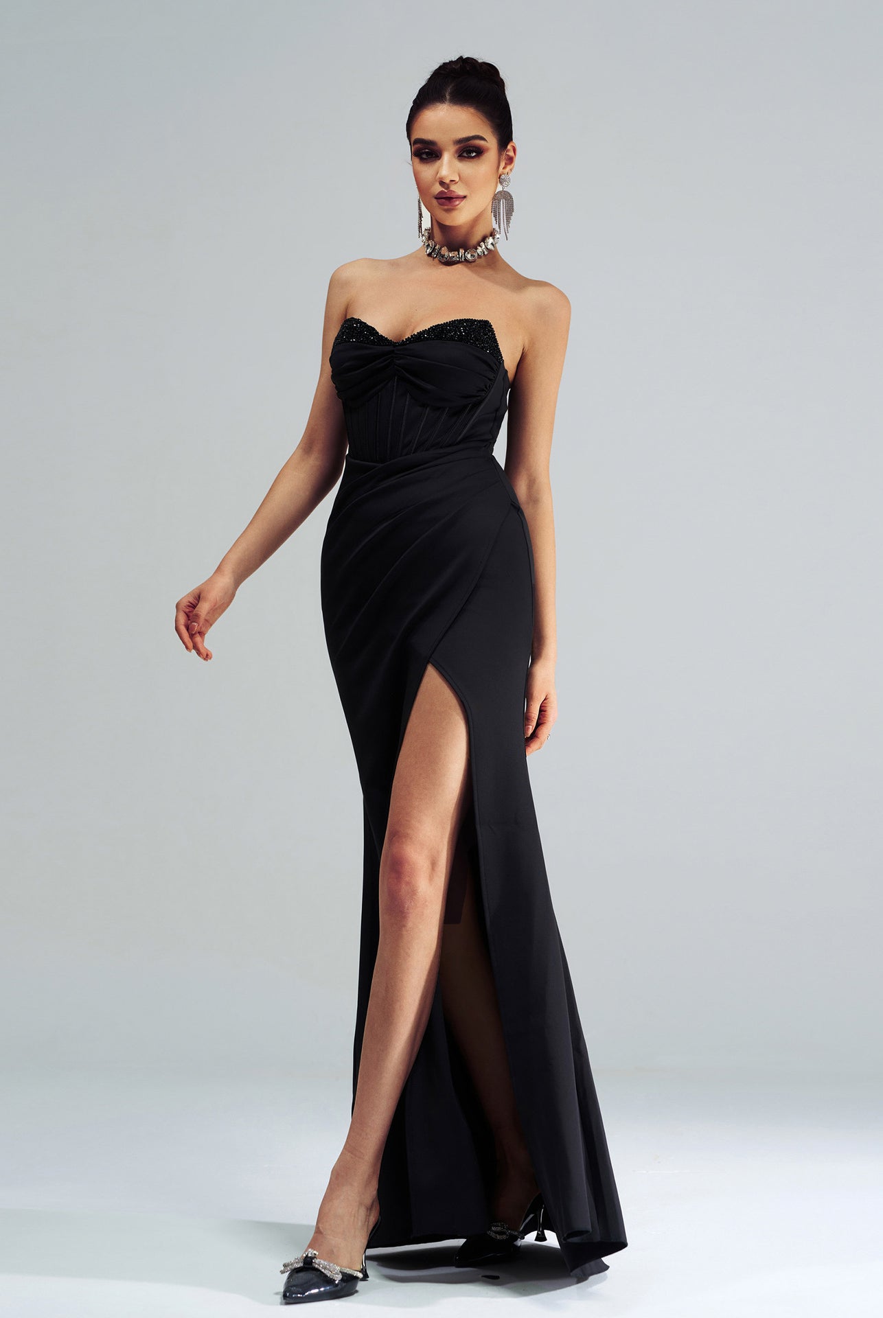 Elegant black strapless evening gown with high side slit for fashionable occasions