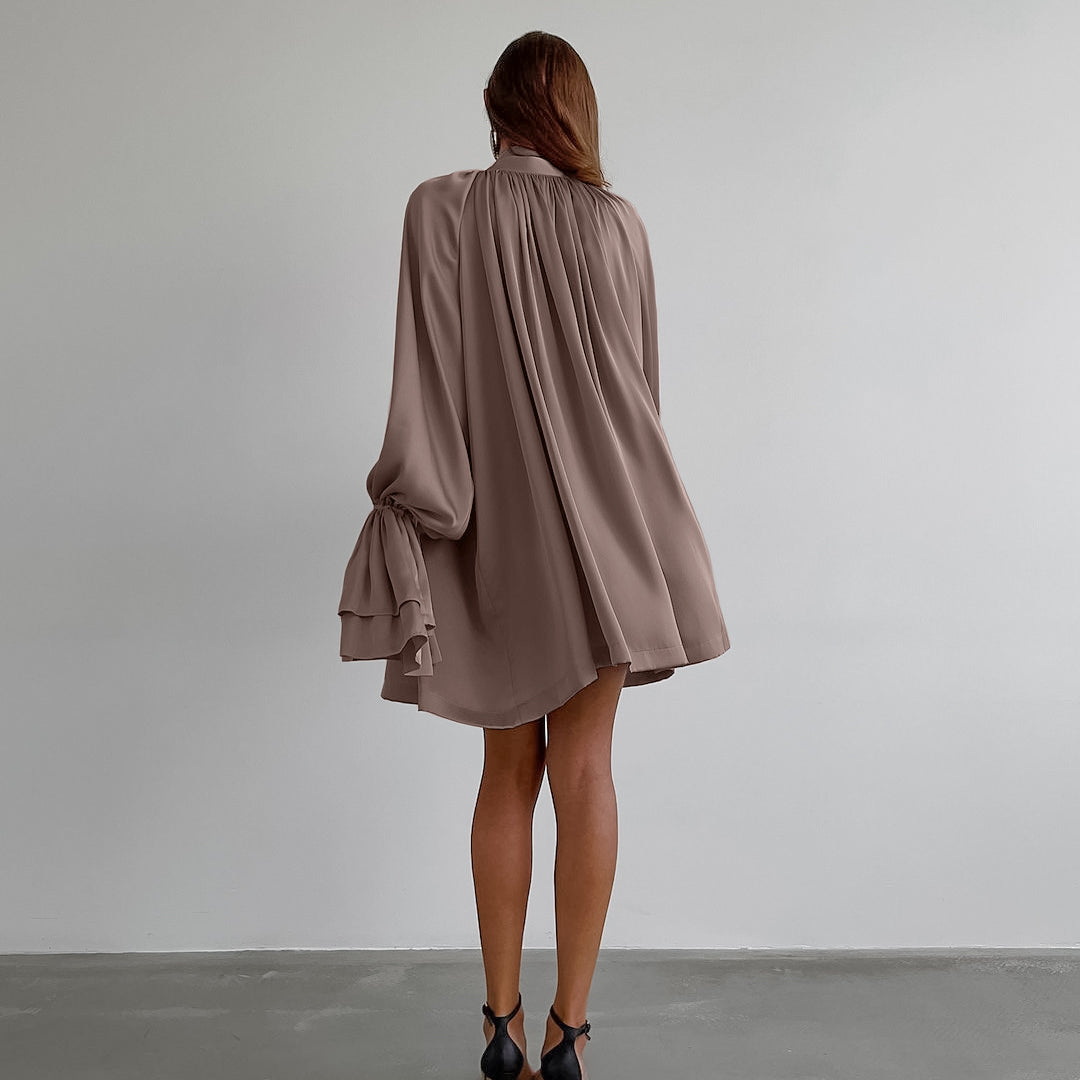 Flowy mauve satin dress featuring billowing long sleeves and gathered back design