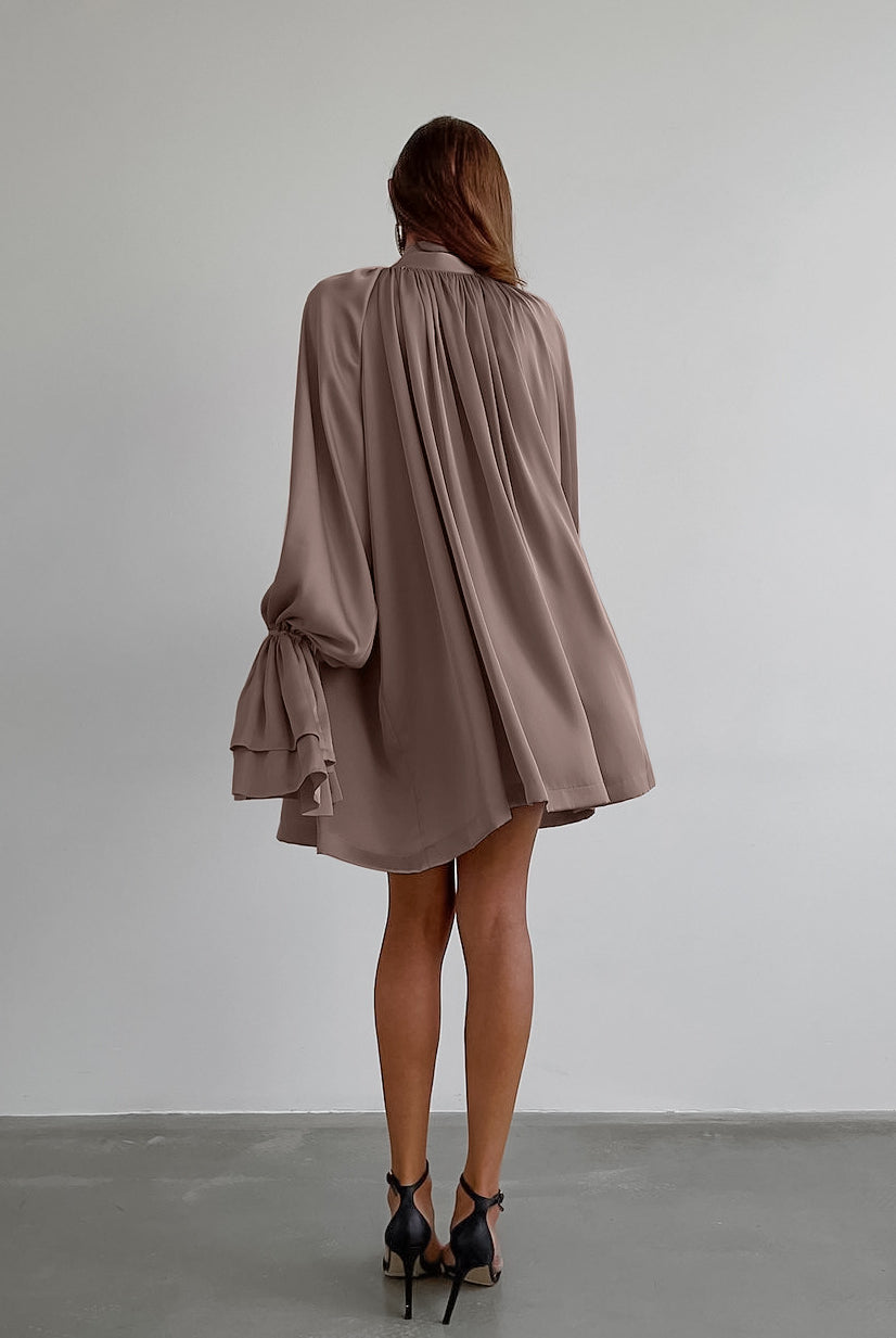 Flowy mauve satin dress featuring billowing long sleeves and gathered back design