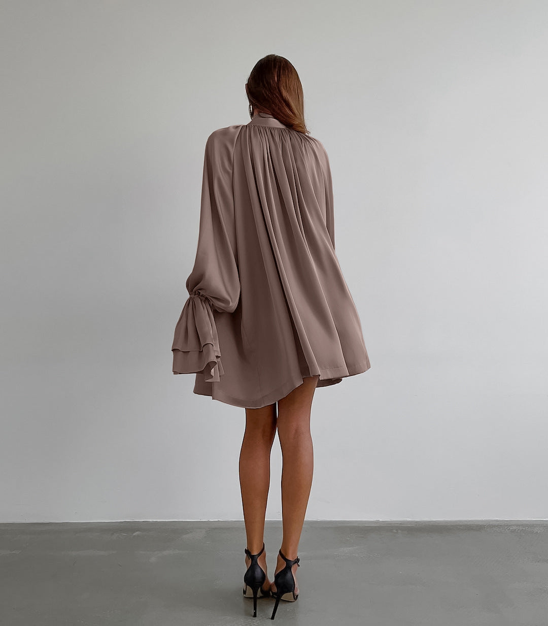 Flowy mauve satin dress featuring billowing long sleeves and gathered back design
