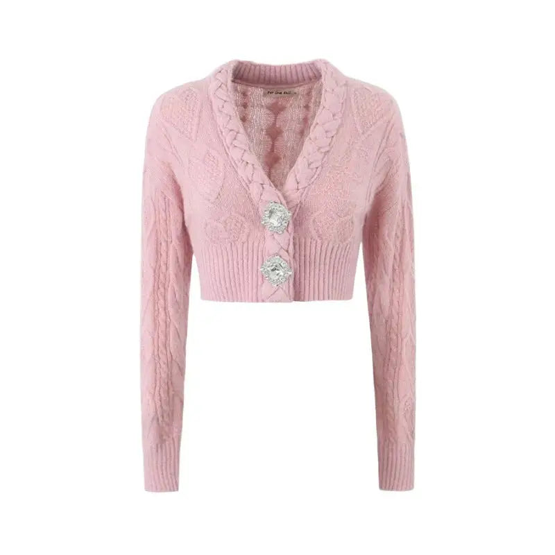 Pink knitted cardigan sweater coat featuring cable knit pattern and flower buttons