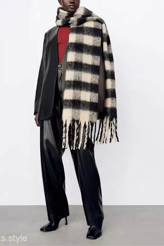 Stylish outfit with a black white wool scarf, dark suit, and red top for fashion enthusiasts