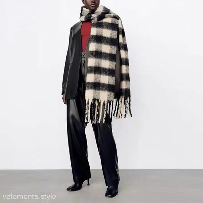 Stylish outfit with a black white wool scarf, dark suit, and red top for fashion enthusiasts