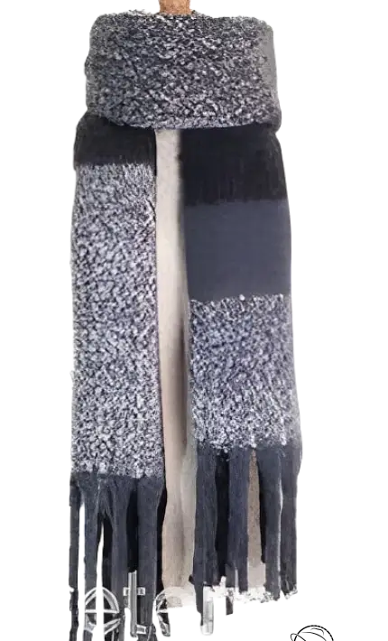 Wool stitching scarf featuring black and gray color blocks with tasseled fringe