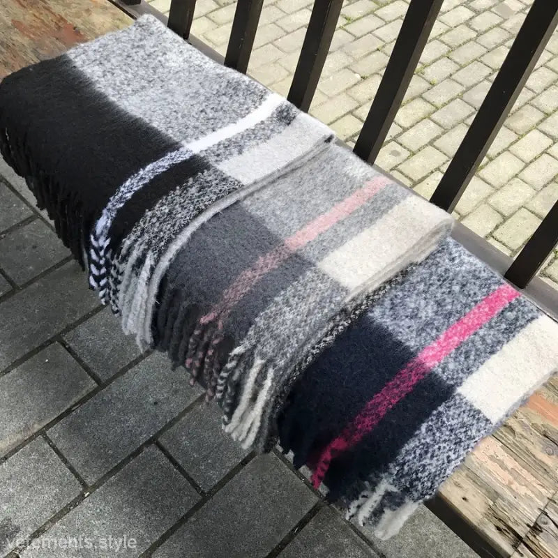 Woven Wool Stitching Scarf in Rose Plaid Navy Blue Print draped over a railing