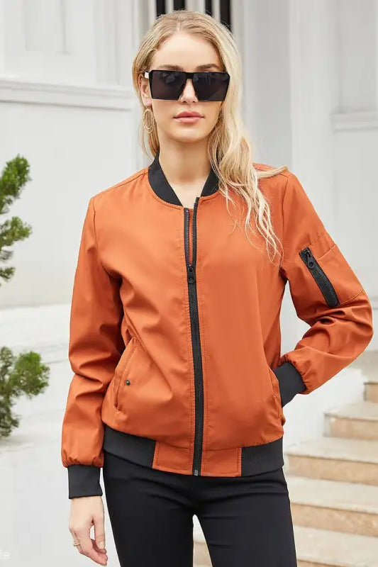 Blonde woman in orange bomber jacket, showcasing Army Green Casual Varsity Jacket