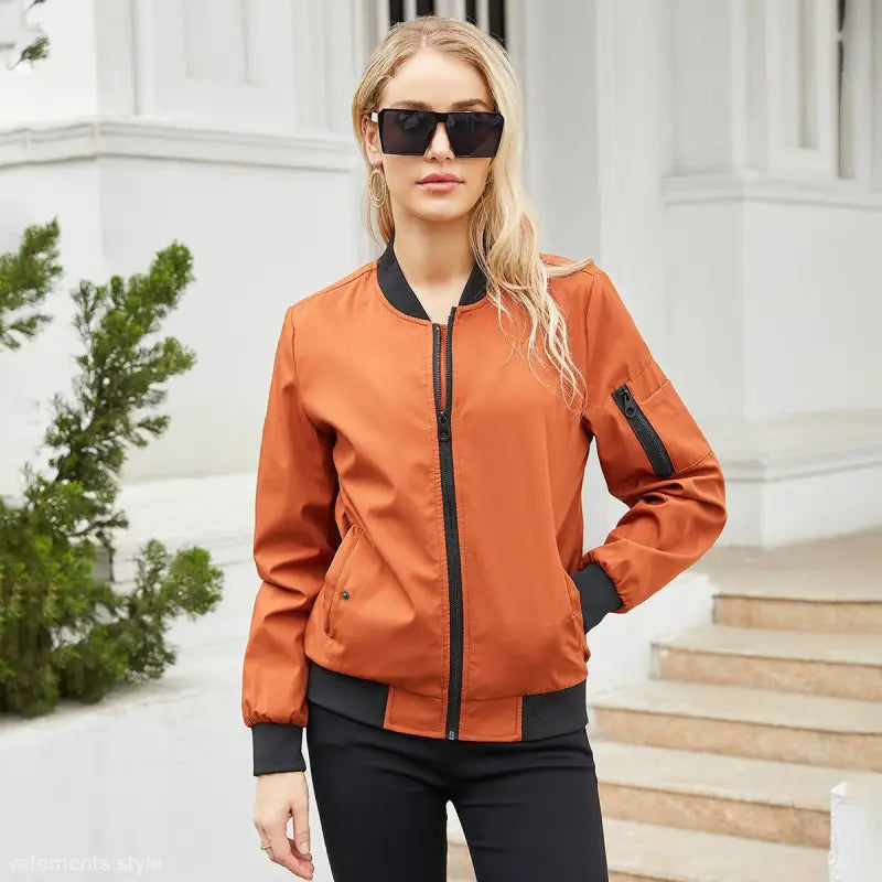 Blonde woman in orange bomber jacket, showcasing Army Green Casual Varsity Jacket