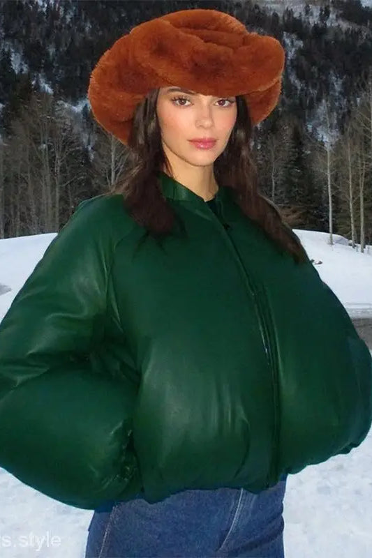 Woman in army green cotton cozy jacket with zipper and pockets in snowy landscape