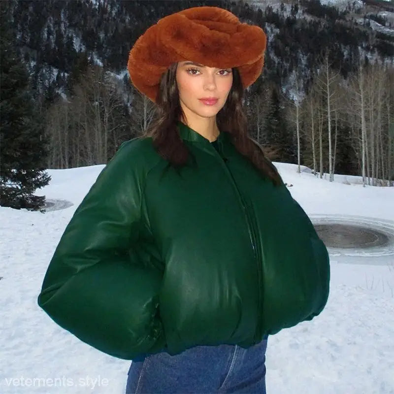 Woman in army green cotton cozy jacket with zipper and pockets in snowy landscape