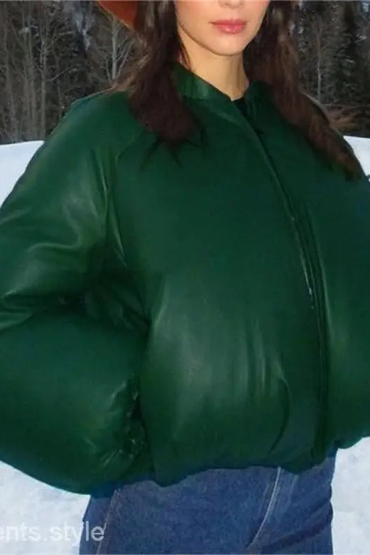 Woman in army green cotton cozy jacket with zipper and pockets in snowy outdoor setting