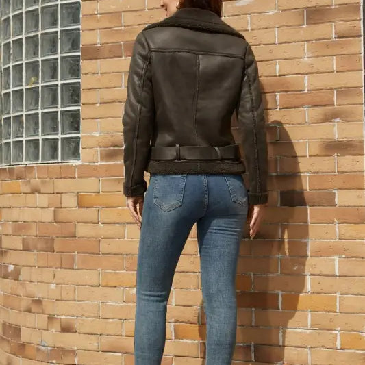 Woman wearing an army green faux shearling jacket with belt and pockets, stylish leather look