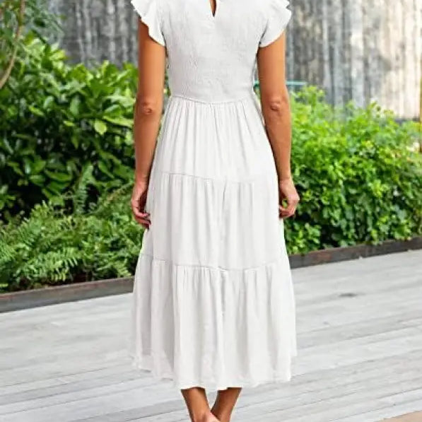 White tiered midi dress featuring flounced large swing design with ruffle and cutout details