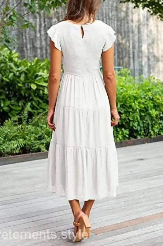 White tiered midi dress featuring flounced large swing design with ruffle and cutout details