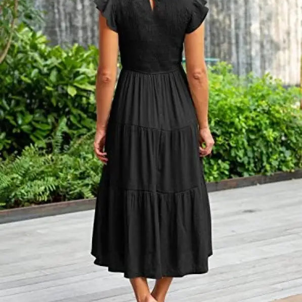 Black tiered midi dress featuring flounced large swing design with ruffle and cutout details