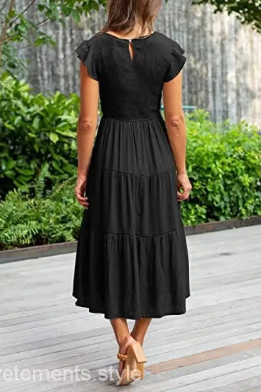 Black tiered midi dress featuring flounced large swing design with ruffle and cutout details