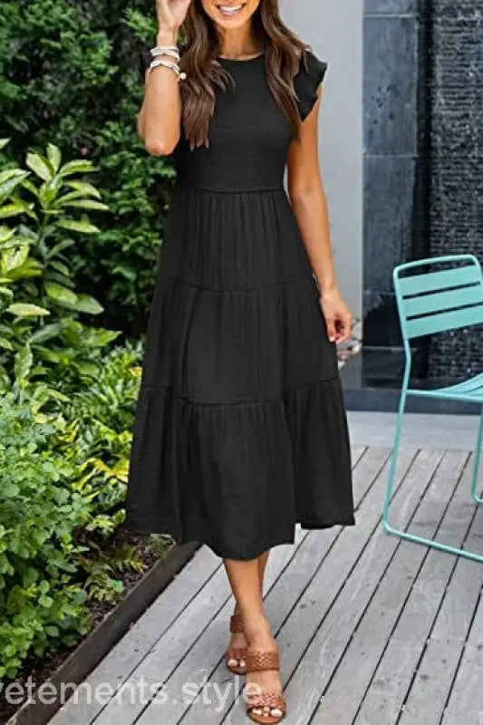 Black tiered midi dress featuring flounced large swing design with cutout details