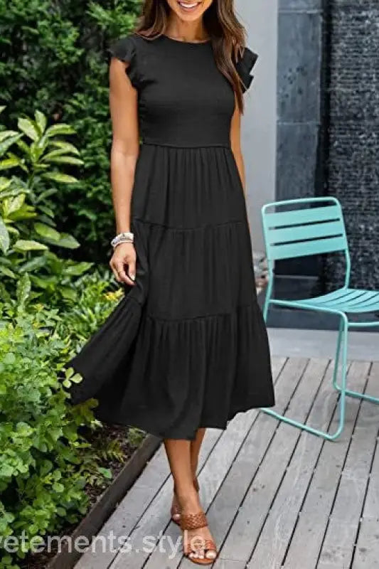 Black tiered midi dress featuring flounced large swing style with cutout details