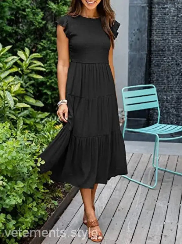 Black tiered midi dress featuring flounced large swing style with cutout details