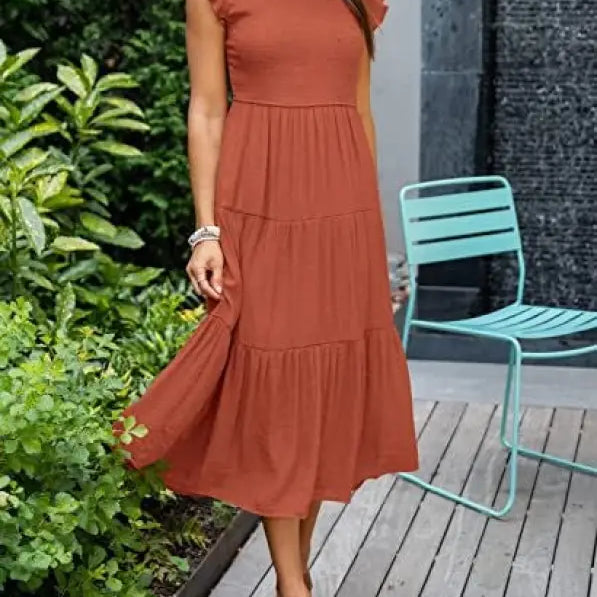 Rust-colored tiered midi dress featuring a flounced large swing silhouette with cutout details