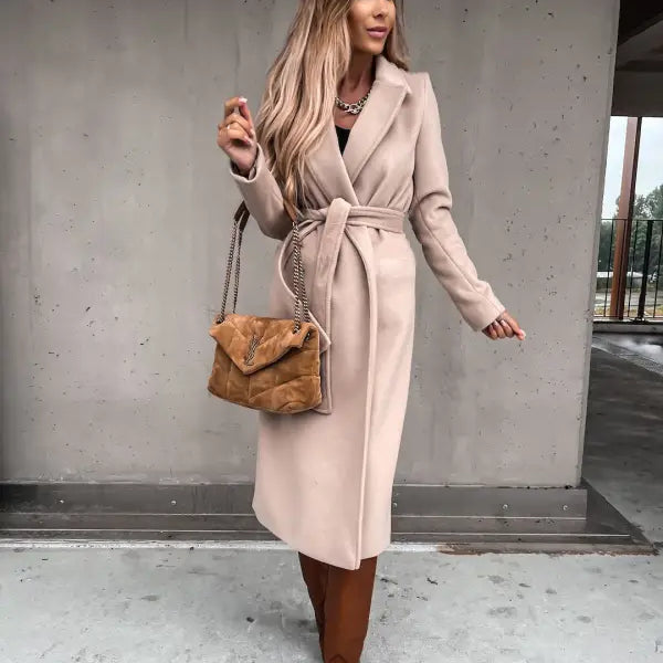 Long beige belted coat paired with army green polo collar long sleeved top and brown boots