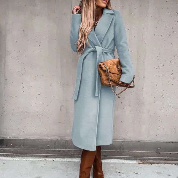 Woman in a long pale blue woolen coat with tie belt over an Army Green Polo Collar Long Sleeved Top