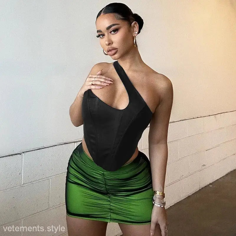 Woman wearing a stylish black shoulder vest boning corset with a green skirt for summer style