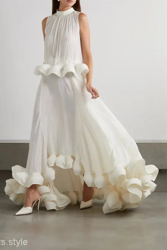Elegant white sleeveless gown featuring asymmetric patchwork ruffled details for summer