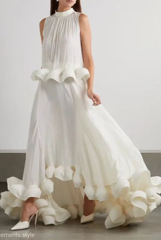 Elegant white sleeveless gown featuring asymmetric patchwork ruffled details in a two piece suit
