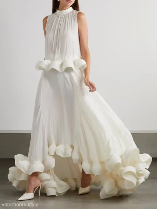 Elegant white sleeveless gown featuring asymmetric patchwork ruffled details in a two piece suit