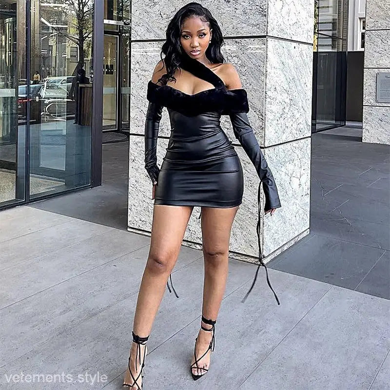 Woman in a black faux leather sheath dress with tie shoulder detail and high heels