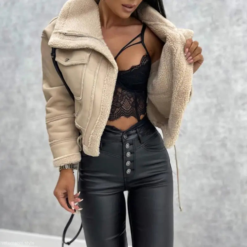 Woman’s attractive faux shearling jacket paired with black leather pants for stylish fall wear