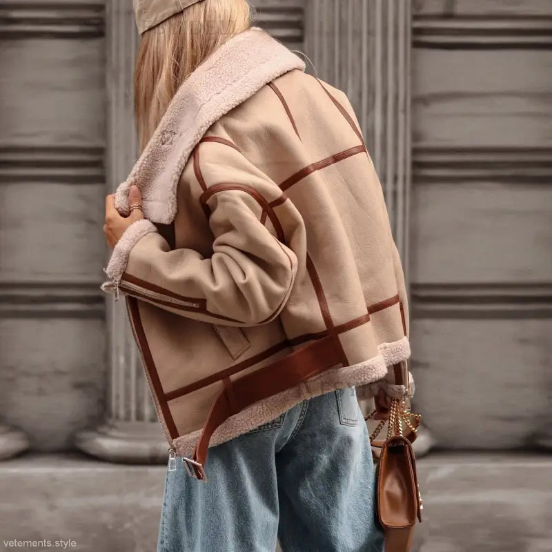 Beige and brown plaid shearling-lined coat locomotive jacket over blue jeans for autumn winter