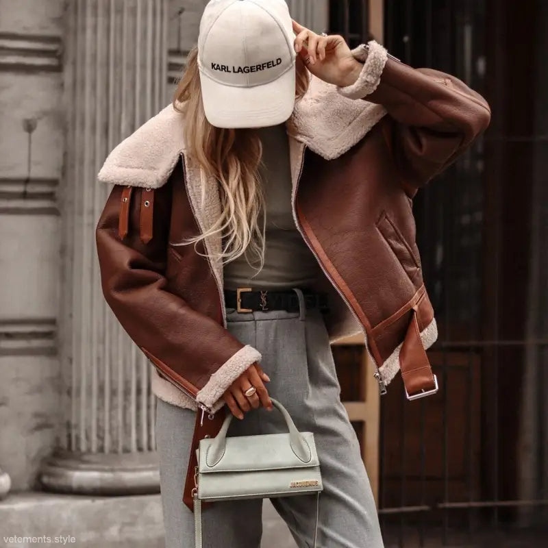 Brown Leather Shearling Jacket with White Karl Lagerfeld Cap and Gray Pants for Autumn Winter
